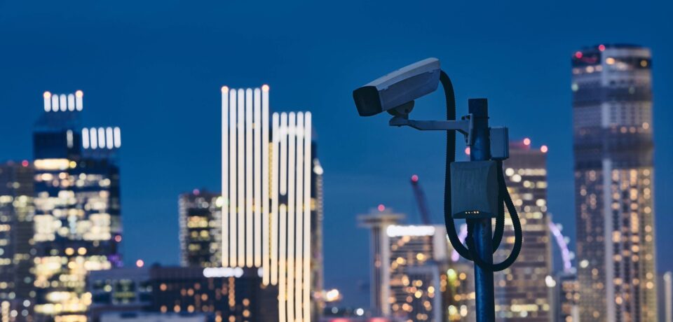 security-camera-against-illuminated-urban-skyline-2025-02-16-11-01-50-utc security-camera-against-illuminated-urban-skyline-2025-02-16-11-01-50-utc